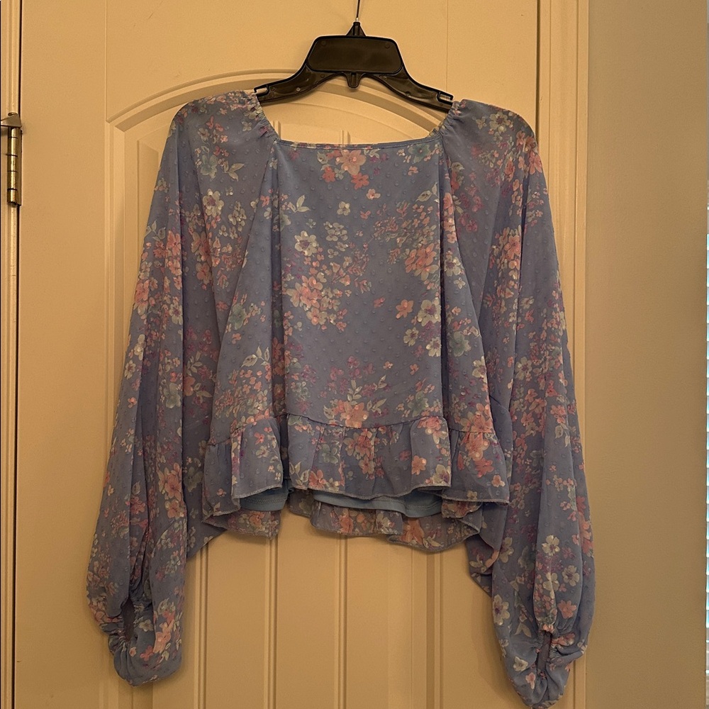 Floral blue blouse with ruffled hem and open back